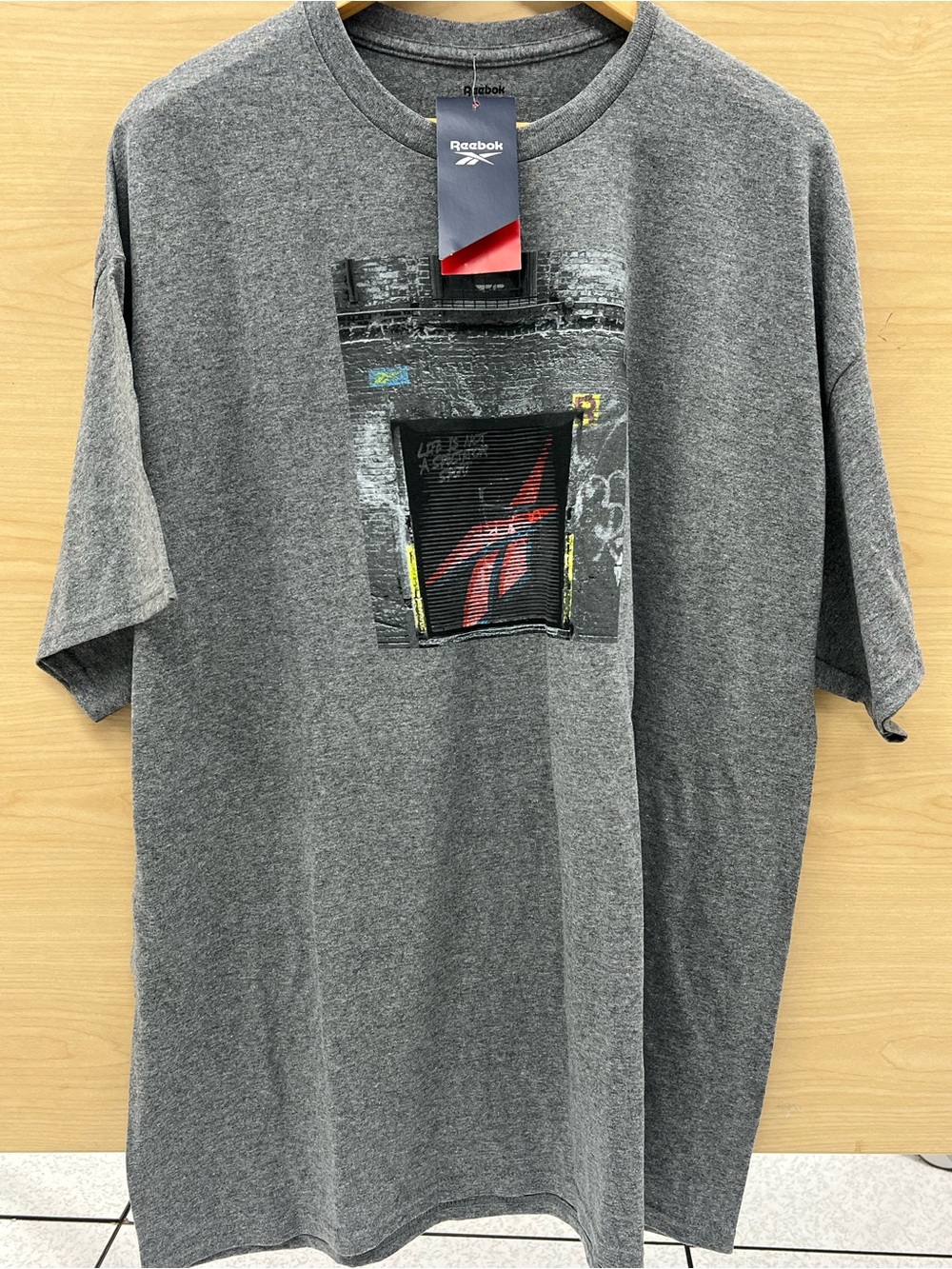 Reebok Gray Short-Sleeve Graphic Tee with Red Logo Accent
